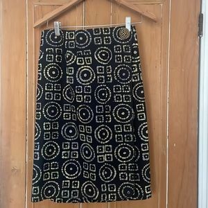 An original designer skirt with navy background and yellow/gold pattern